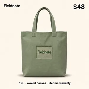 A straight-on, flat e-commerce product thumbnail of a sturdy canvas tote bag in a soft sage-green color, centered on a clean light neutral background with a soft, even shadow beneath it and a minimal embroidered patch detail on the front. Around/over the image, small clean product info: a brand name "Fieldnote" at the top corner, a price "$48" in bold, and a small spec line "12L · waxed canvas · lifetime warranty" beneath the bag. Cozy, tactile, marketplace product-photo style, crisp detail, no tilt, no 3D perspective.